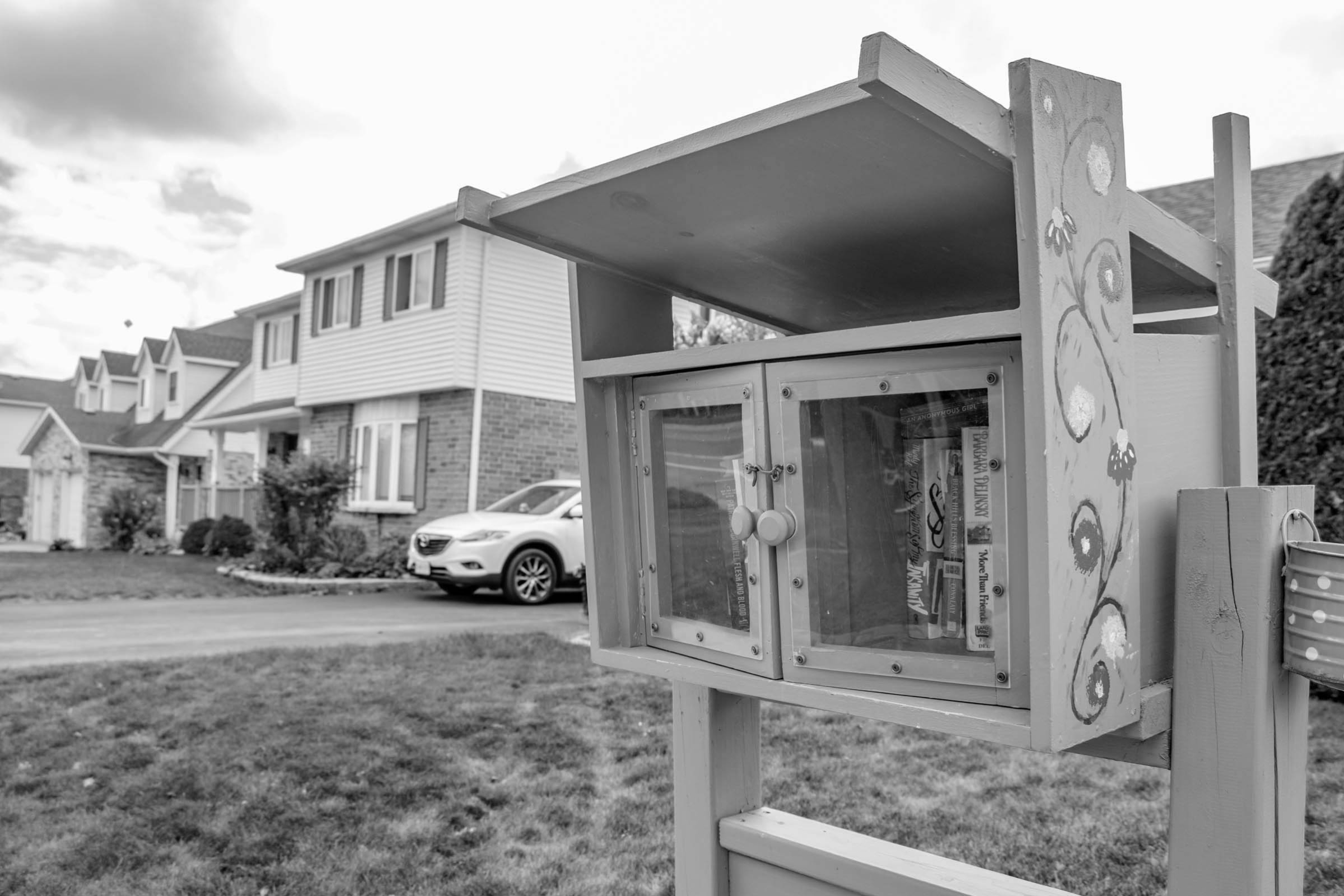 A little library on the front lawn of a neighbourhood home in Highland West, Kitchener, Ontario