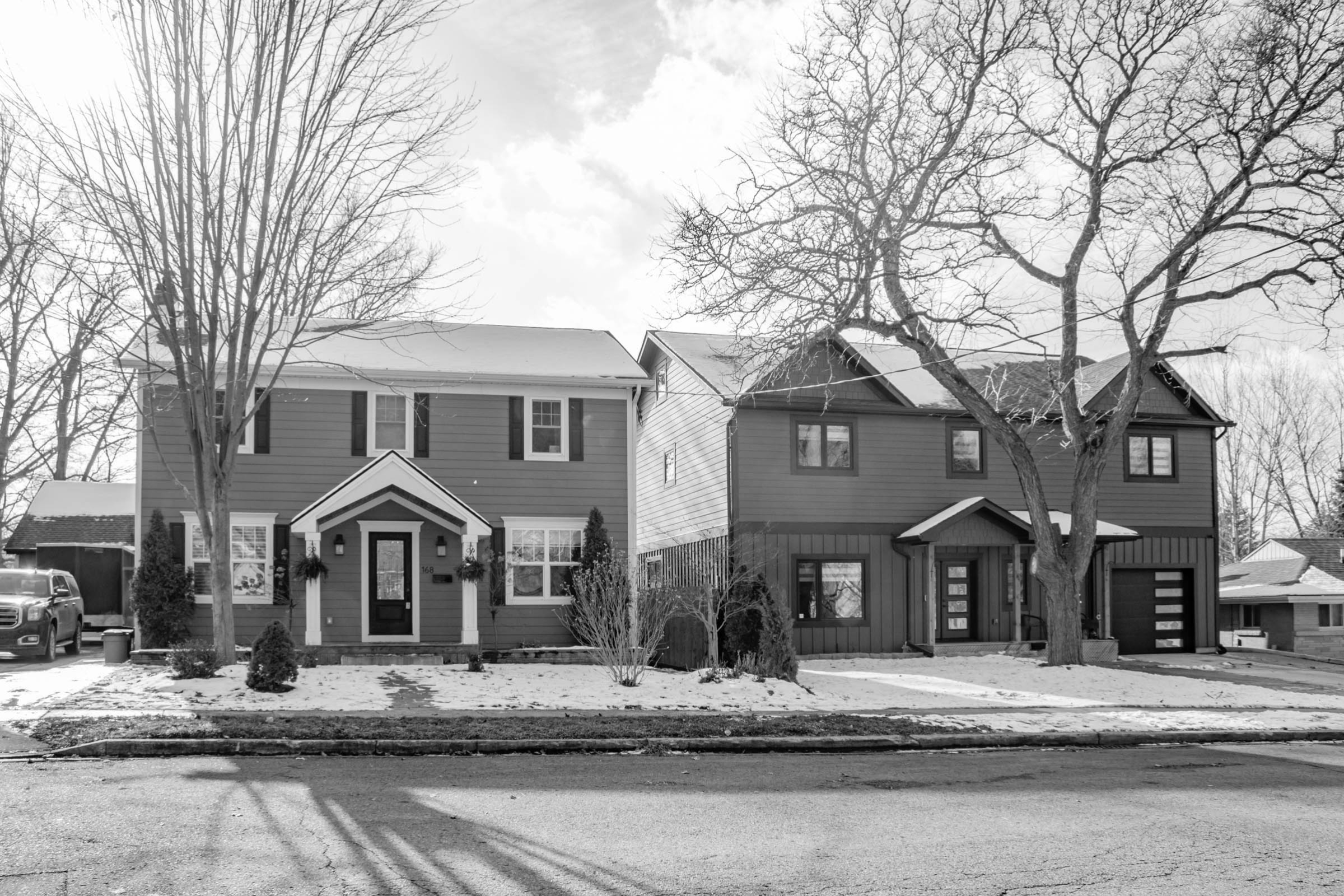 a photo of two homes on a street in hespeler