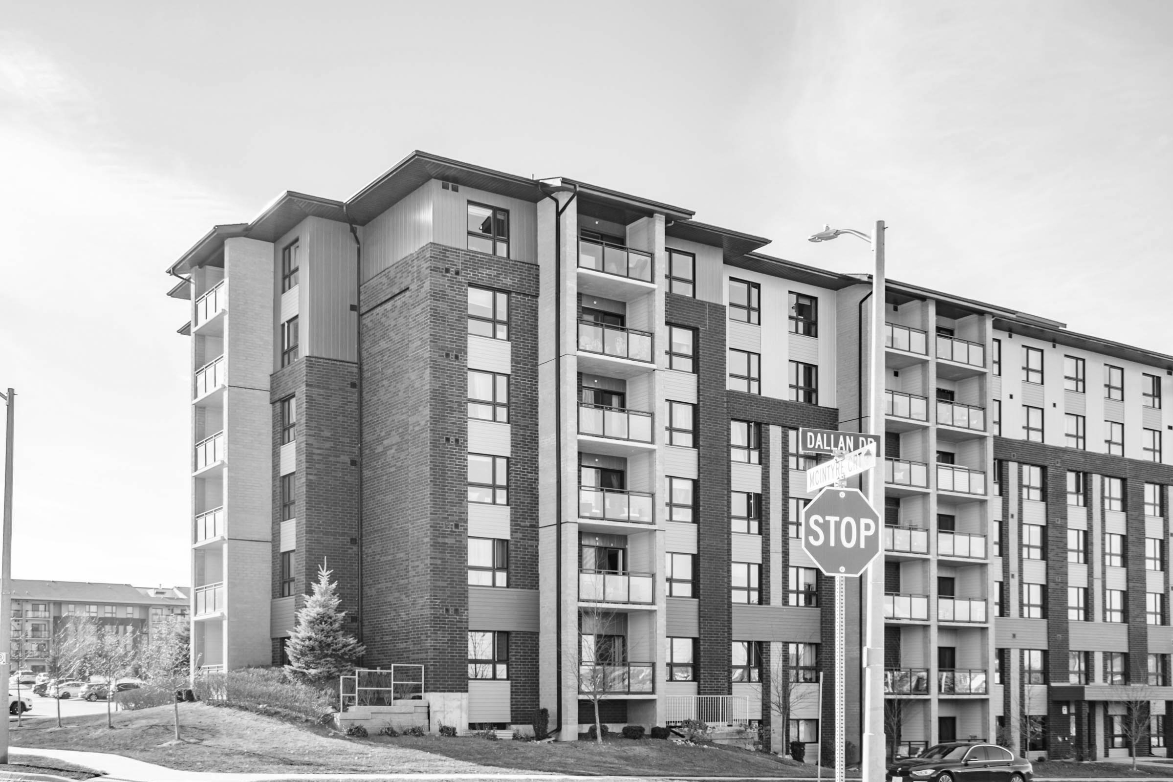 a photo of the intersection at dallan drive and mcintyre court with a condo building in the background